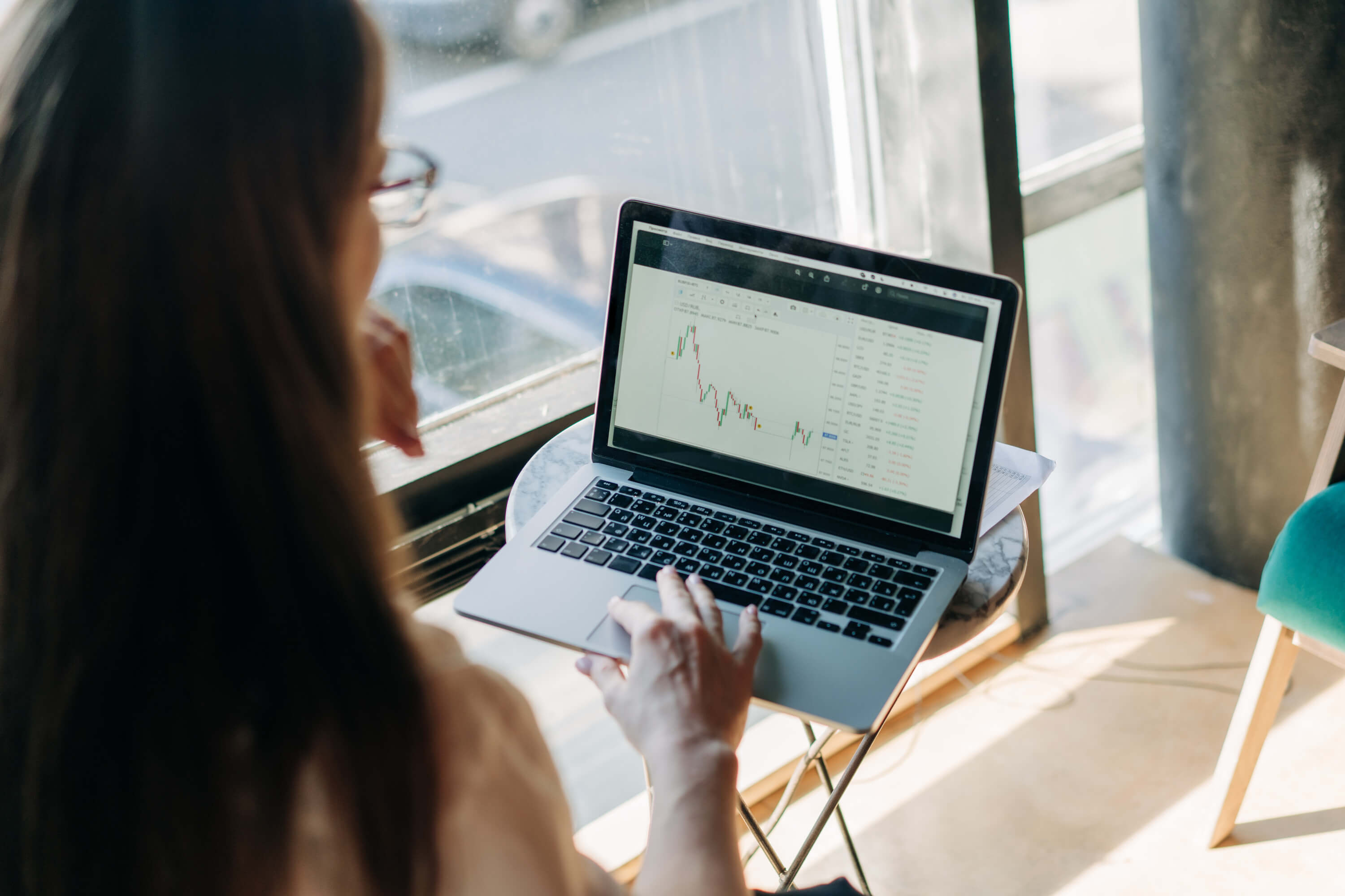 Person trading on laptop